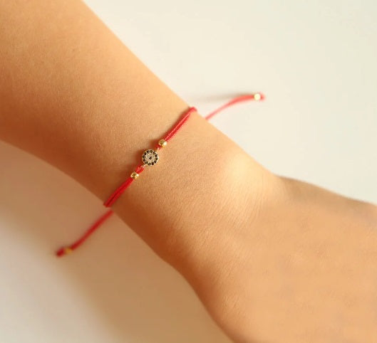 <p>Mini CZ Eye Red Cord Bracelet</p>